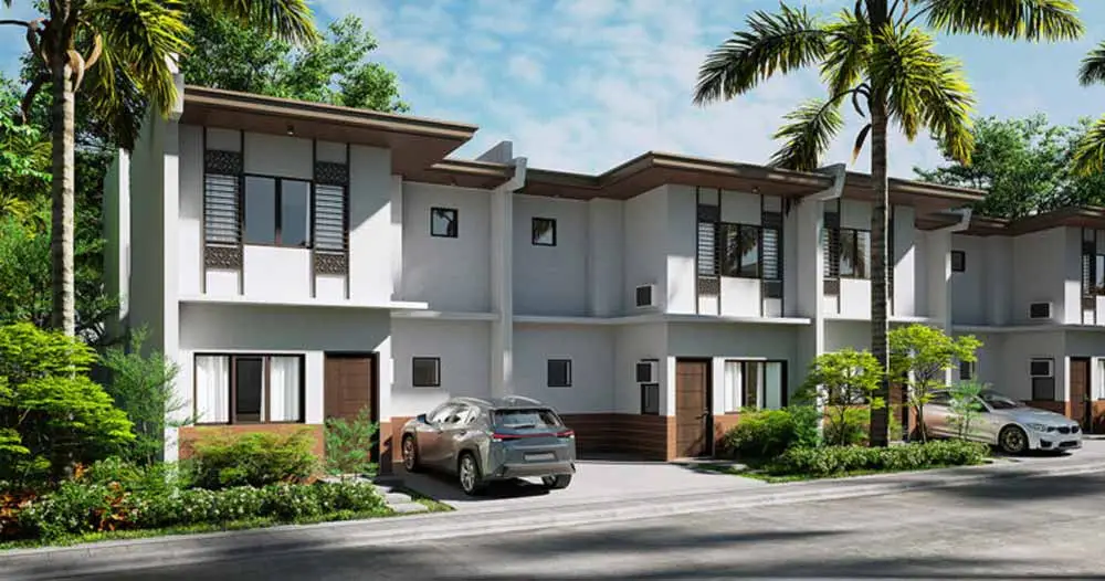 An image of a modern townhouse with parked cars.