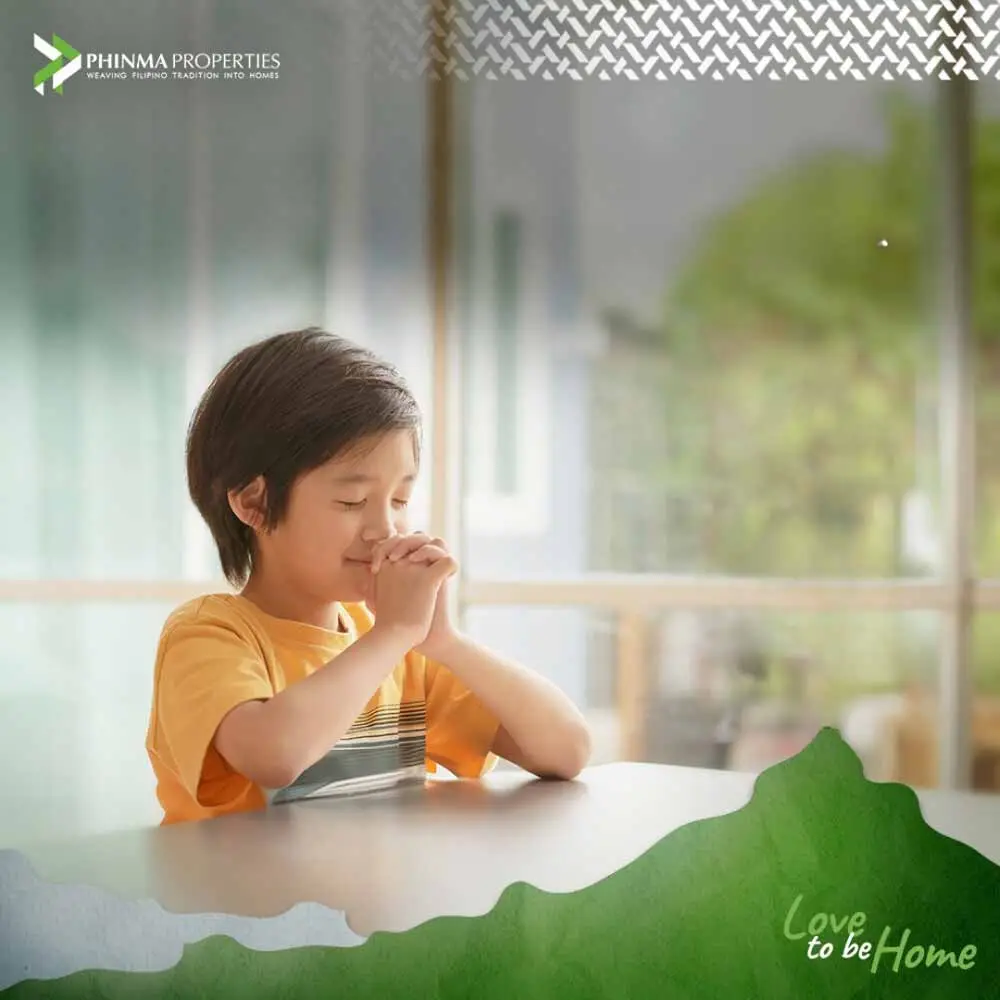 A child praying inside their home.