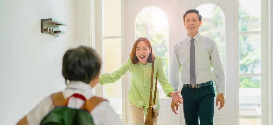 Family moment in a bright entryway, symbolizing comfort, connection, and coming home to the city of smiles.