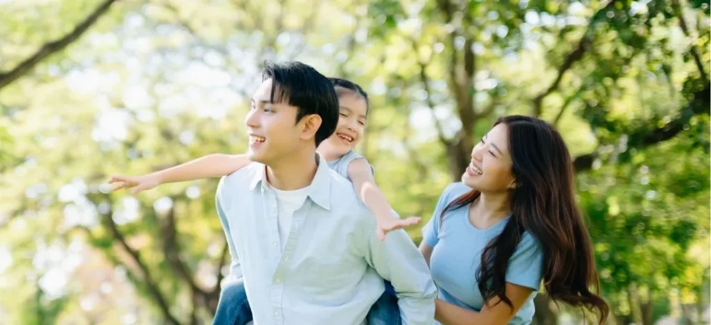 An aspirational image of a happy family embracing the relaxed outdoor routine and cool air of their new filipino neighborhood Davao home at PHINMA Maayo Tugbok.