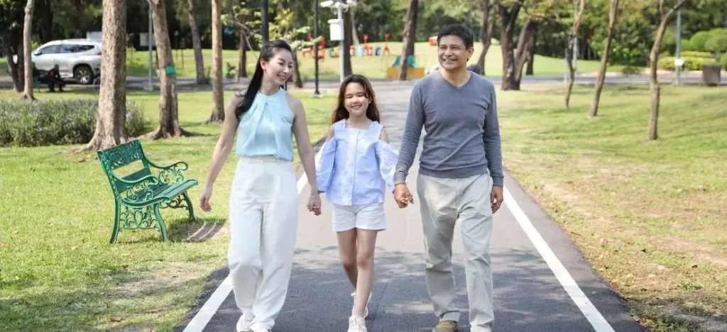 Residents enjoying the open, green spaces of a PHINMA development, illustrating the benefits of sustainable communities in the Philippines.