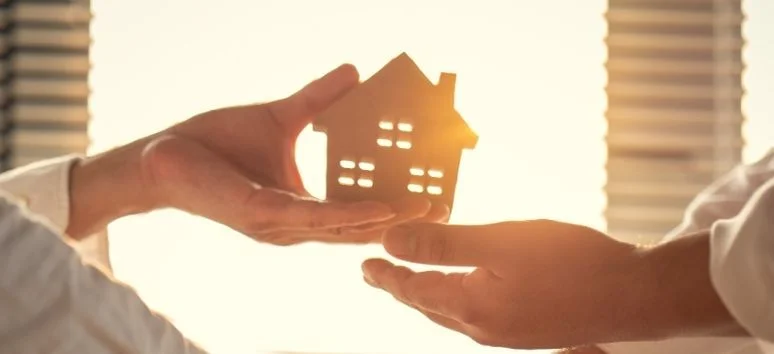 Close-up of a symbolic house handover, illustrating a trusted real estate developer in the Philippines guide for Likha Estates.