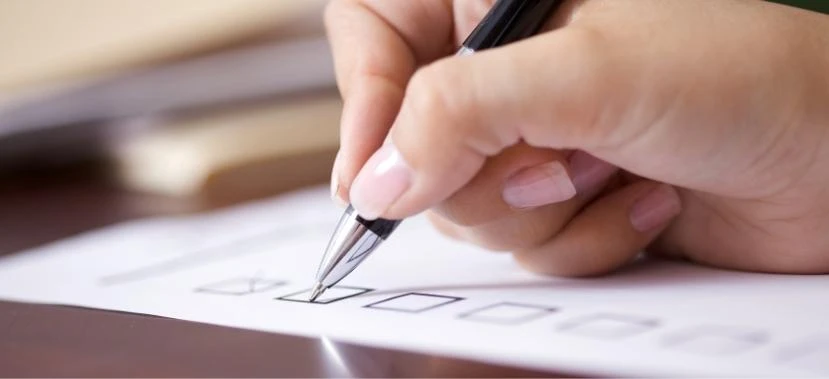 Focused individual following a simple checklist to buying a house in the Philippines to prepare required IDs and certificates.