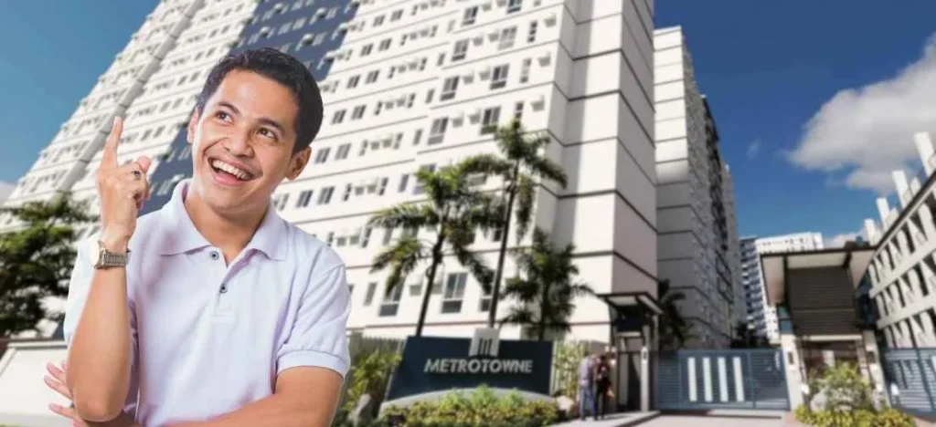 Happy man standing before Metrotowne, representing the success of buying a condo in Las Piñas for long-term value.