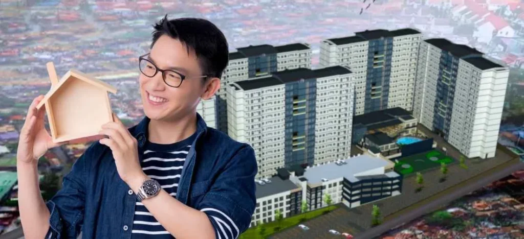 Happy homeowner beside a PHINMA Metrotowne scale model, illustrating how a condo is a good investment for capital appreciation.