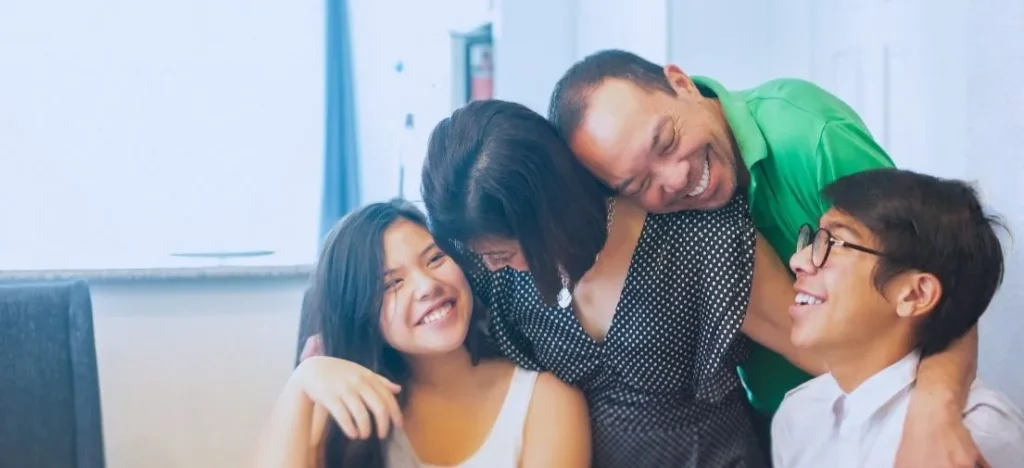 A Filipino family bonding in their modern Saludad home, providing a rewarding wellness lifestyle for frequent travelers and OFWs.